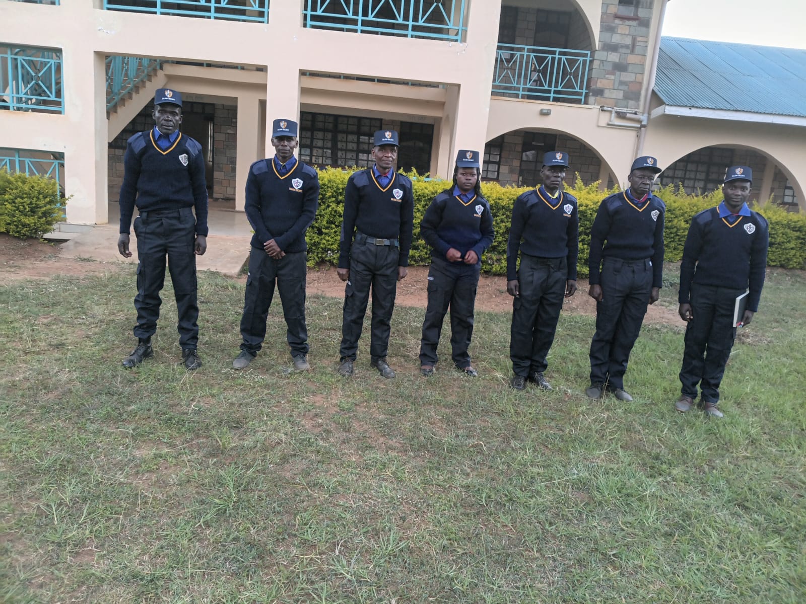 Officers standing in front of a client building